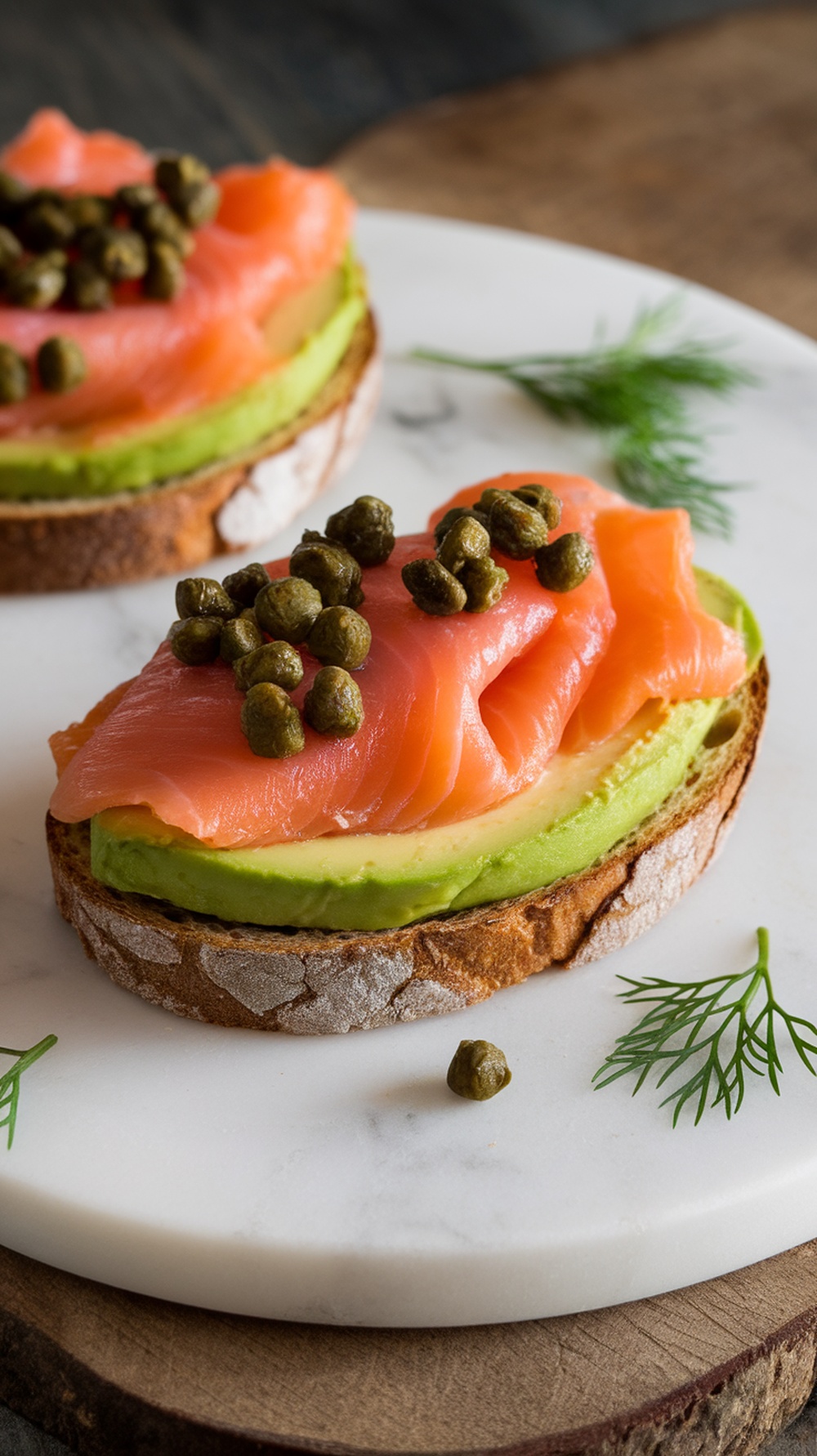 A delicious plate of smoked salmon avocado toast topped with capers and dill.