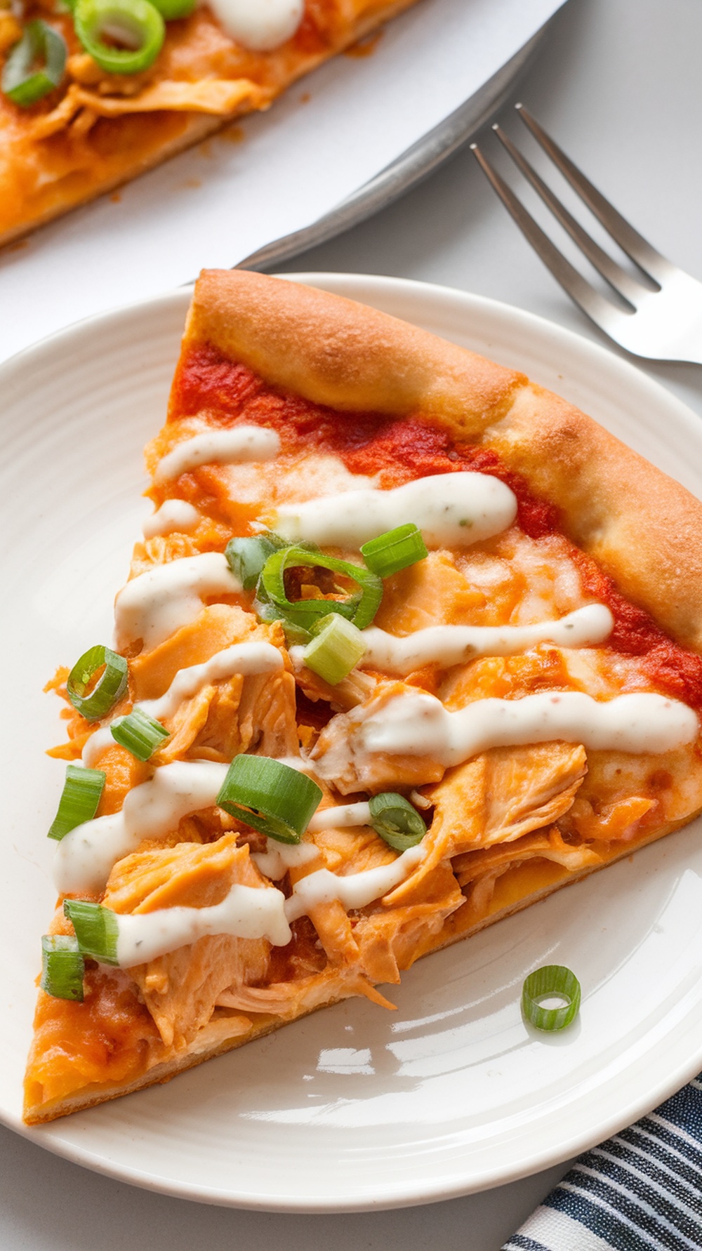 Slice of Buffalo Shredded Chicken Pizza with green onions and ranch dressing