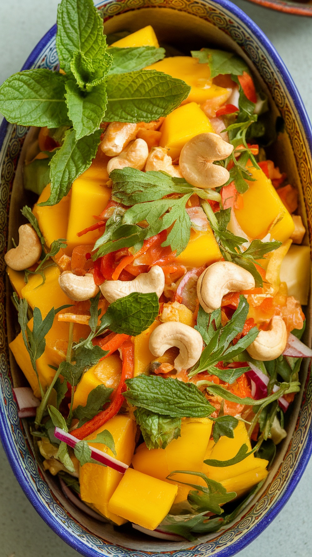 A vibrant Thai Mango Salad with mango, vegetables, and herbs