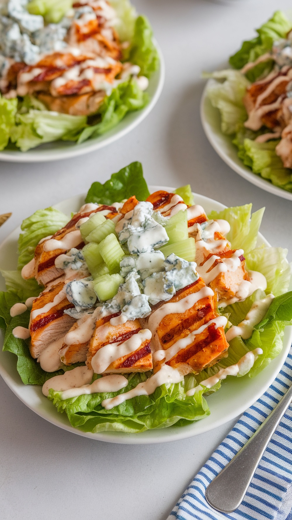 Buffalo Grilled Chicken Salad with Blue Cheese Crumbles on a plate