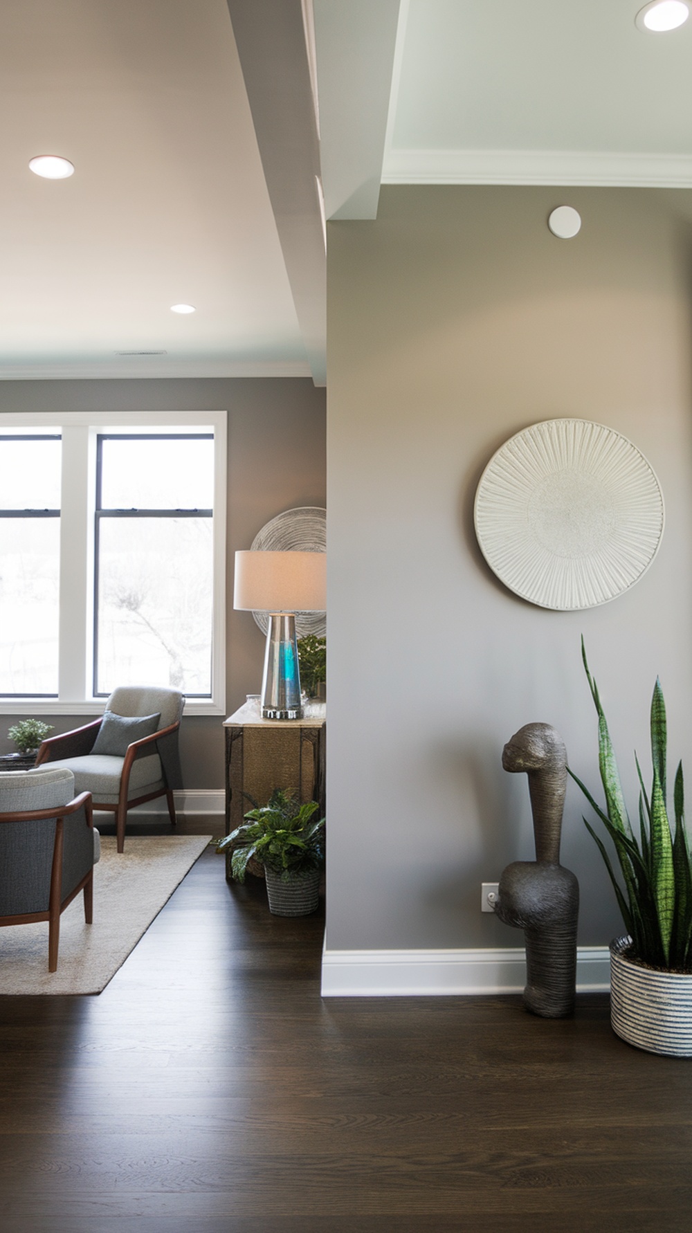 A cozy living area featuring Modern Gray walls, stylish furniture, and decorative plants.